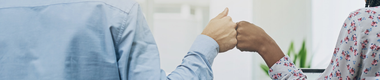 two people fist bumping